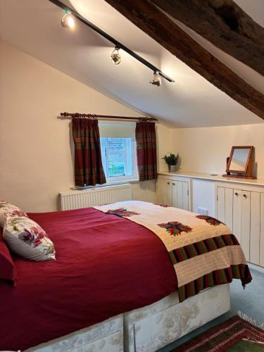a bedroom with a large bed in a attic at The Old Stores in Bury Saint Edmunds