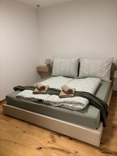 a bed with two slippers on top of it at Apartment Leitner in Haiming