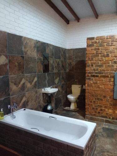 a bathroom with a bath tub and a sink at Mountain Guesthouse in Pretoria