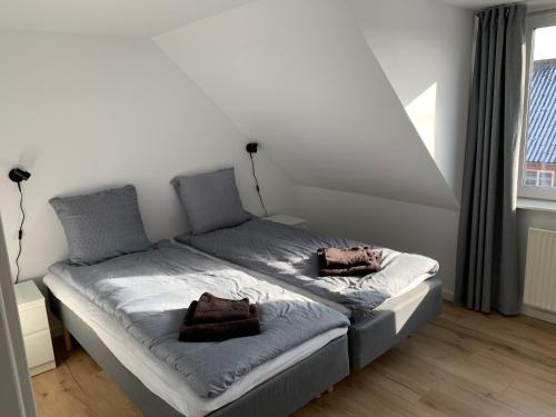 a bed with two pillows on it in a room at Familiehus in Nakskov