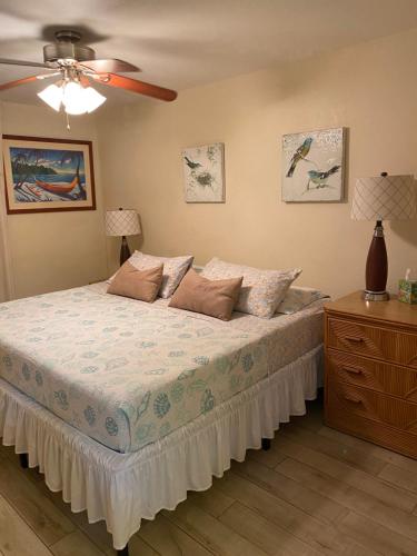 a bedroom with a bed and a ceiling fan at Nani Kai Hale # 204 Hotel District! in Kihei