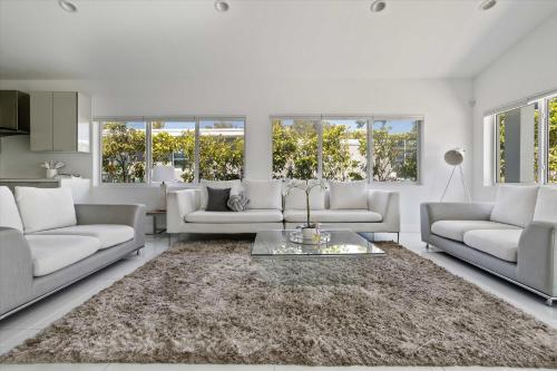 a living room with white couches and a rug at Luxury House 4 beds heated Pool w Jaccuzzi in North Bay Village