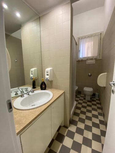 a bathroom with a sink and a toilet at Viva Accomodation in Bergamo