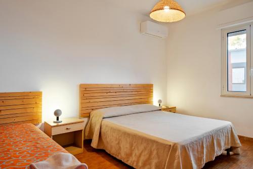 a bedroom with a bed and a window at Villetta Patitari in Gallipoli
