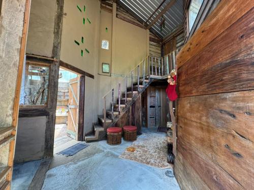 a woman is standing in a room with a building at Chalé João de barro in Bonito