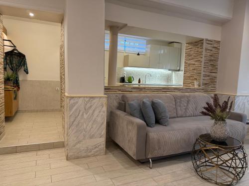 a living room with a couch and a kitchen at Mediterranean in Preveza