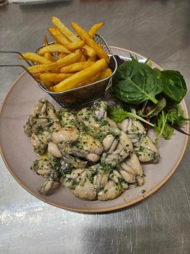 a plate of food with a plate of french fries at La Bona Taula By A&J in Rochefort-Montagne
