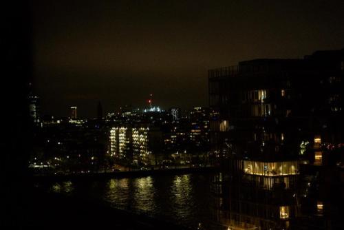 a view of a city at night with a body of water at Stylish Luxury 1BR in Chelsea in London