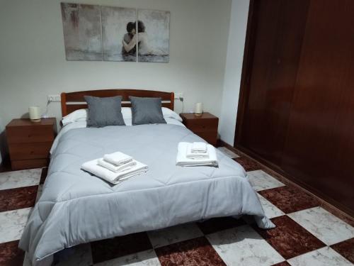 a bedroom with a bed with towels on it at La Cañada in Baena
