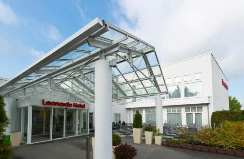 a large white building with a glass roof at Leonardo Hotel Heidelberg in Heidelberg