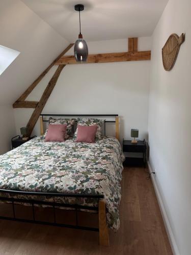 a bedroom with a large bed in a attic at Blanche maison calme in Neuville-sur-Vanne