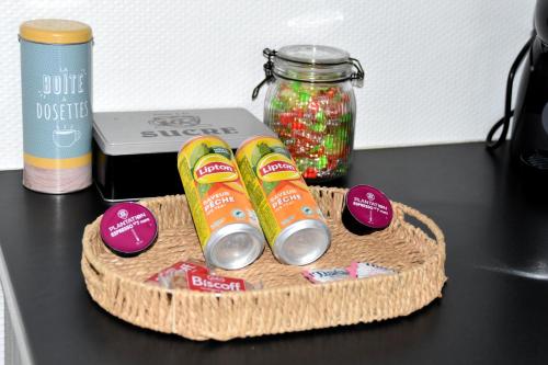 a table with a jar of candy and two soda cans at La Cachette Ludique in Orléans