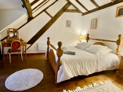 a bedroom with a large bed in a attic at La grange de Moli in Vigeois