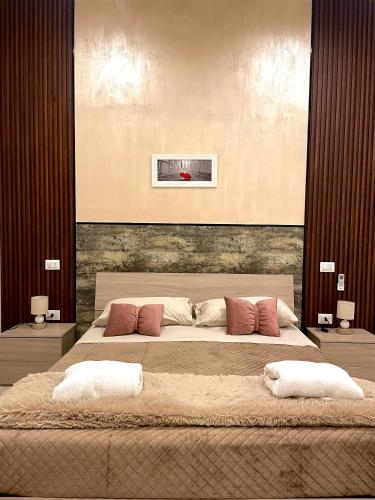 a bedroom with a large bed with two pillows at Dimora Borbonica 1 in Marcianise