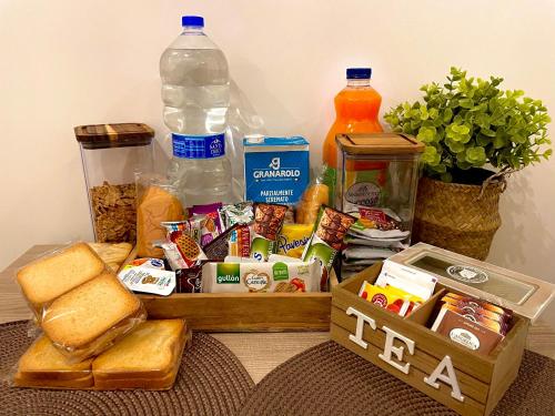 a table with a box of food and bread and drinks at Dimora Borbonica 1 in Marcianise