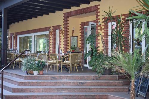 a patio with chairs and tables on a house at Hotel Seeschlösschen in Groß Köris
