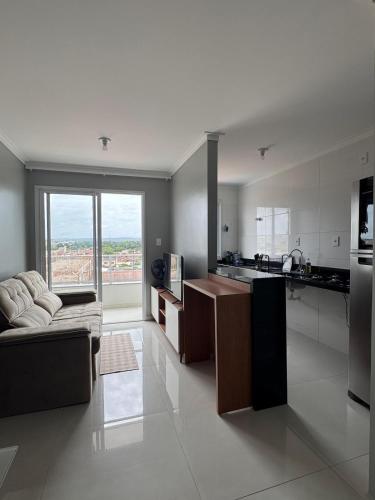 a large kitchen with a couch and a stove top oven at Apartamento confortável em Santarém in Santarém