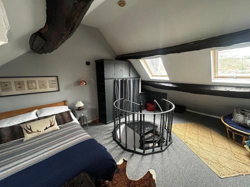 a bedroom with a large bed and a window at Bewdley Riverside Cottage in Bewdley