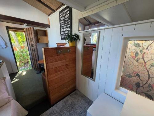 a small room with a door and a window at Surf Shack on Broadway in Waitara