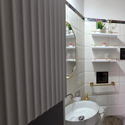a bathroom with a shower curtain and a sink at Casa India in Assemini