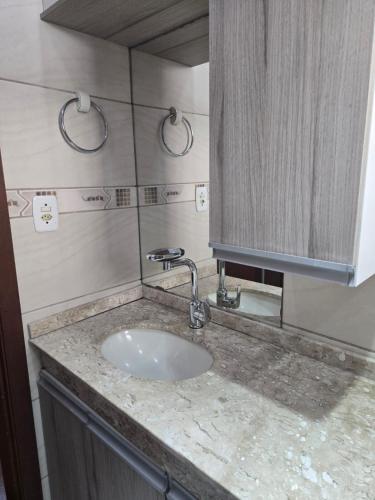 a bathroom counter with a sink and a cabinet at Premium house with pool in Santana do Livramento