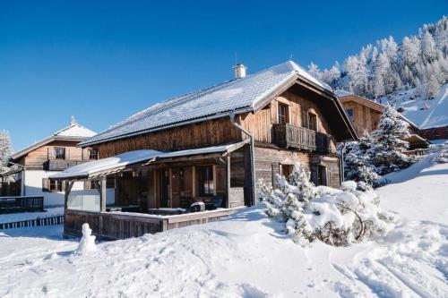 a log cabin with snow on the ground at Almchalet am Katschberg in Katschberghöhe