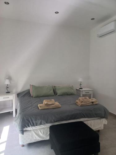 a bedroom with a bed with two towels on it at Muana Escobar in Belén de Escobar