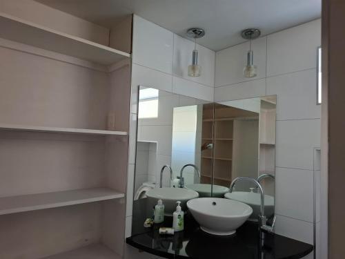 a bathroom with a sink and a mirror at All decked out in Rotorua