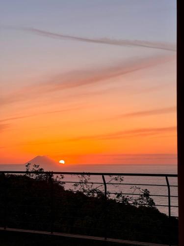a sunset from the balcony of a house at BLUE APARTMENT in VILLA ANGISI in Drapia