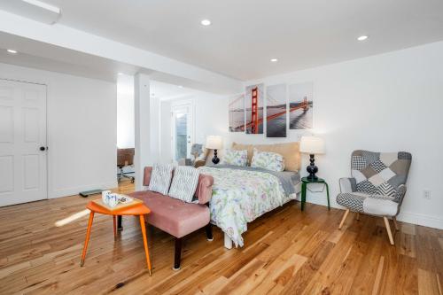 a bedroom with a bed and a chair at Huh's Lodge in San Francisco