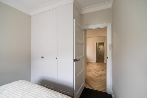 a bedroom with a door leading to a hallway at Manly Waterfront Apartment Harbourside in Sydney