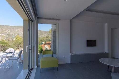 a living room with a tv and a table and chairs at Lavender Cove in Korfos