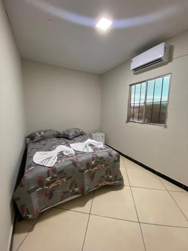 a bedroom with a bed in a room with a window at Aluguel por temporada Triunfo-PE in Triunfo