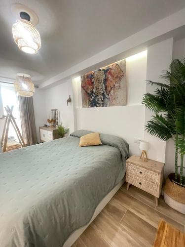 a bedroom with a large bed and a plant at Pontevedra Apartments -New Loft Centro Pontevedra in Pontevedra