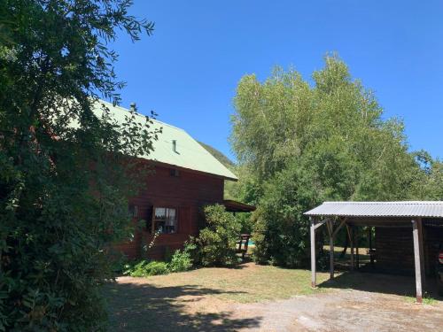 a barn with a pavilion in front of it at Cabaña Vista Las Bravas in Recinto