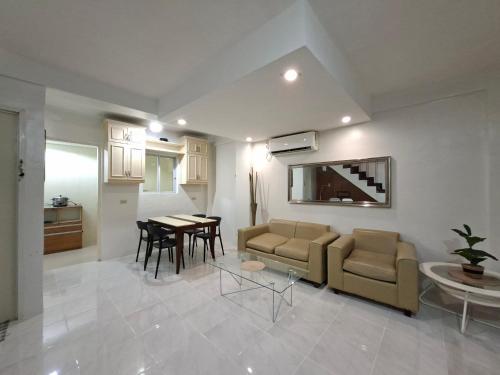 a living room with a couch and a table at Abode86-PGT Townhouse2 in Lapu Lapu City