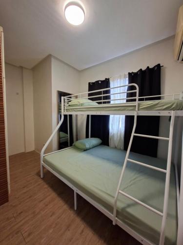 a bedroom with two bunk beds in a room at Abode86-PGT Townhouse2 in Lapu Lapu City