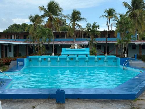 a large blue pool with a bench in the middle at Marvella Club in Nueva Gorgona