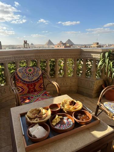 a tray of food on a table on a balcony at Pyramids Mystery Inn in Cairo