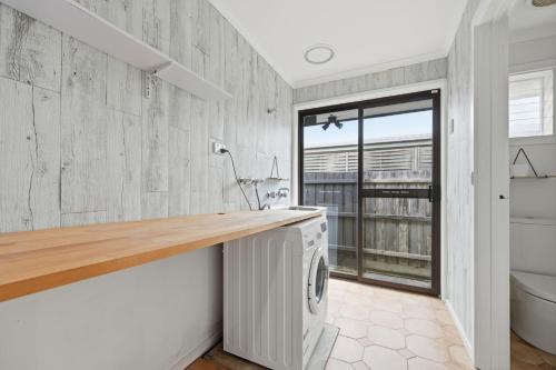 a laundry room with a washer and dryer at Dixon Delight in Inverloch