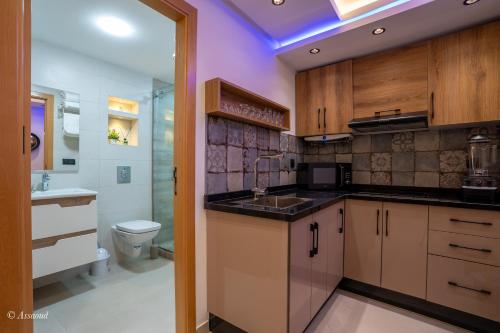 a kitchen with a sink and a toilet at RamoHouse bright home central in Chefchaouen