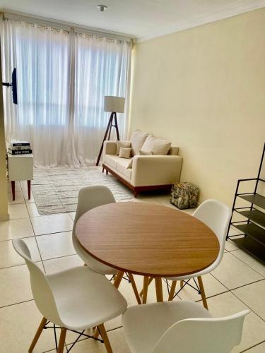 a living room with a table and chairs and a couch at Lar doce lar! in Divinópolis