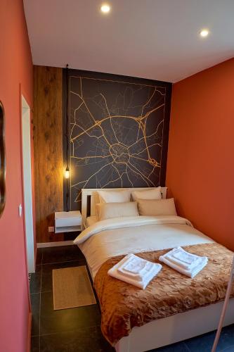 a bedroom with a bed with two towels on it at L'Escapade Tournaisienne in Tournai