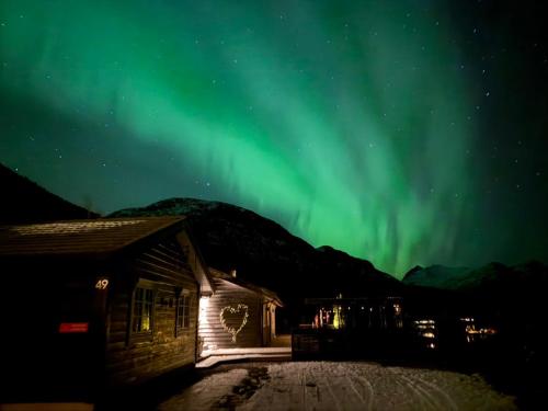 an image of the aurora borealis over a building at Luxury cabin with amazing views in Stryn