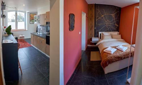 a bedroom with orange walls and a bed in a room at L'Escapade Tournaisienne in Tournai
