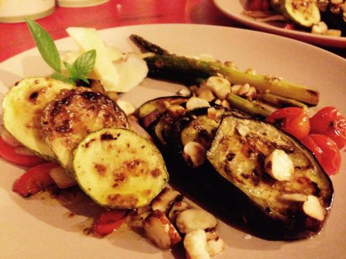 a plate of food with meat and vegetables on a table at Casa Kresala, Surf House in Zorritos
