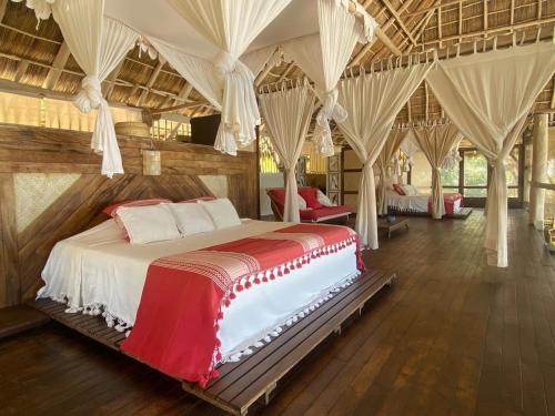 a bedroom with a large bed in a room at Palapa Ganesh in Sayulita