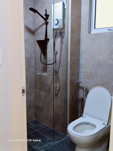 a bathroom with a shower with a toilet at Mesahill Home Stay Nilai in Nilai