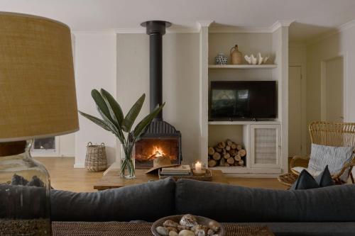 a living room with a couch and a fireplace at Verandah Retreat - A Beach House by the sea in Cowes