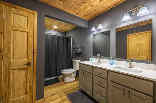 a bathroom with two sinks and a toilet at New listing-- Hocking Hills Modern Cabin in Logan